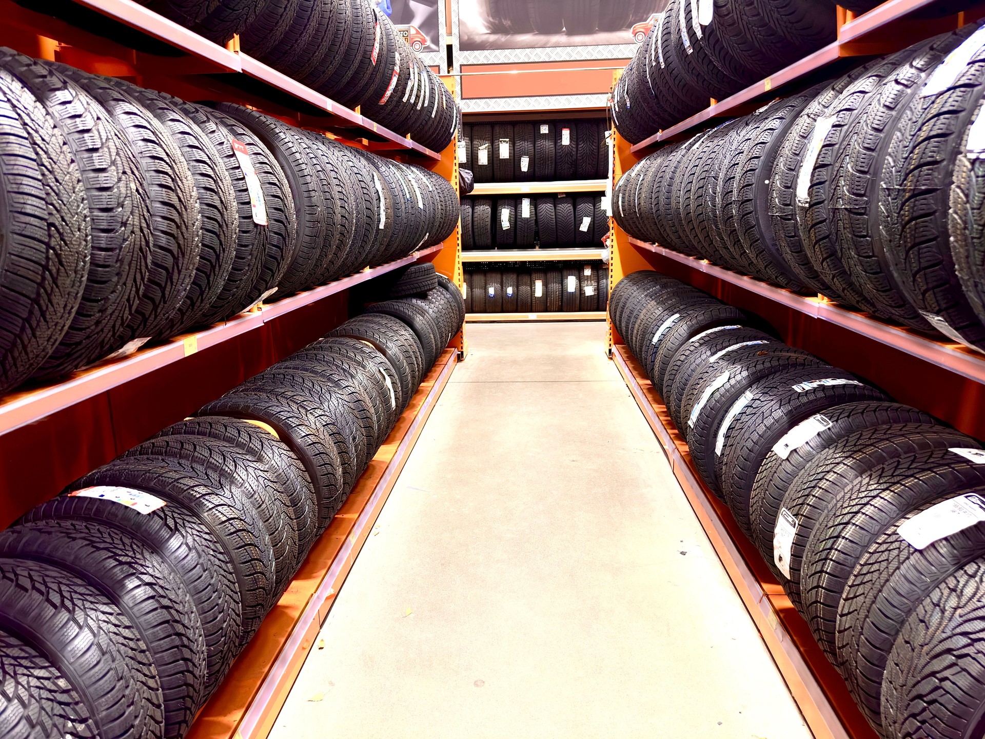 Rows of new car tires in a store.